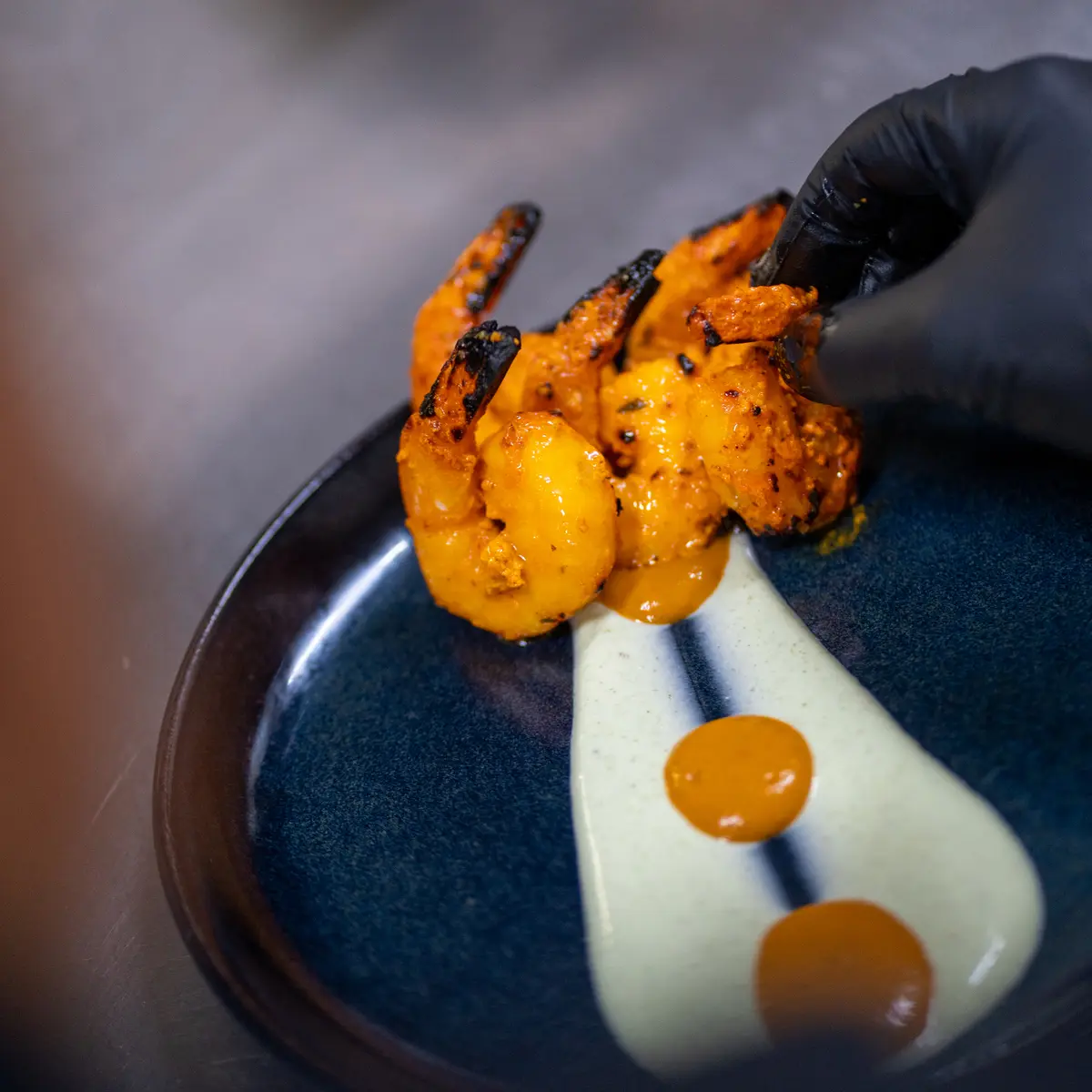 Server plating starter food on a plate.