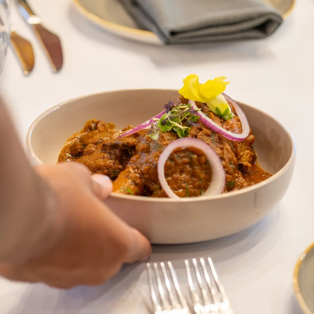 Server serving main food on table.