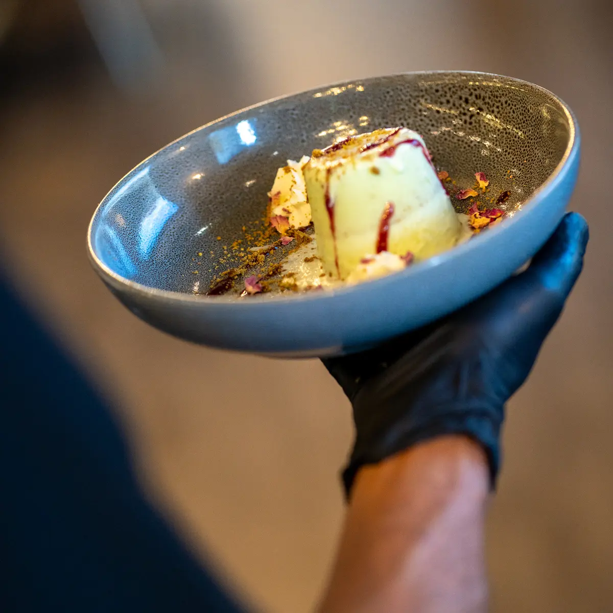 Server holding dessert dish.