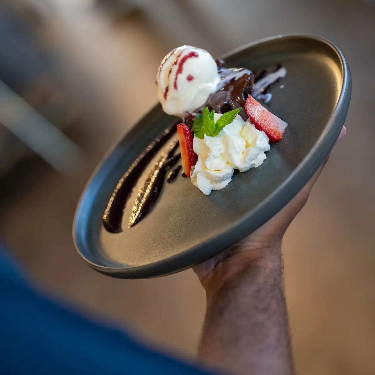 Server holding dessert dish.